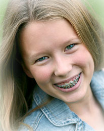 girl with braces outside and smiling