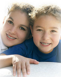 two sisters with braces smiling